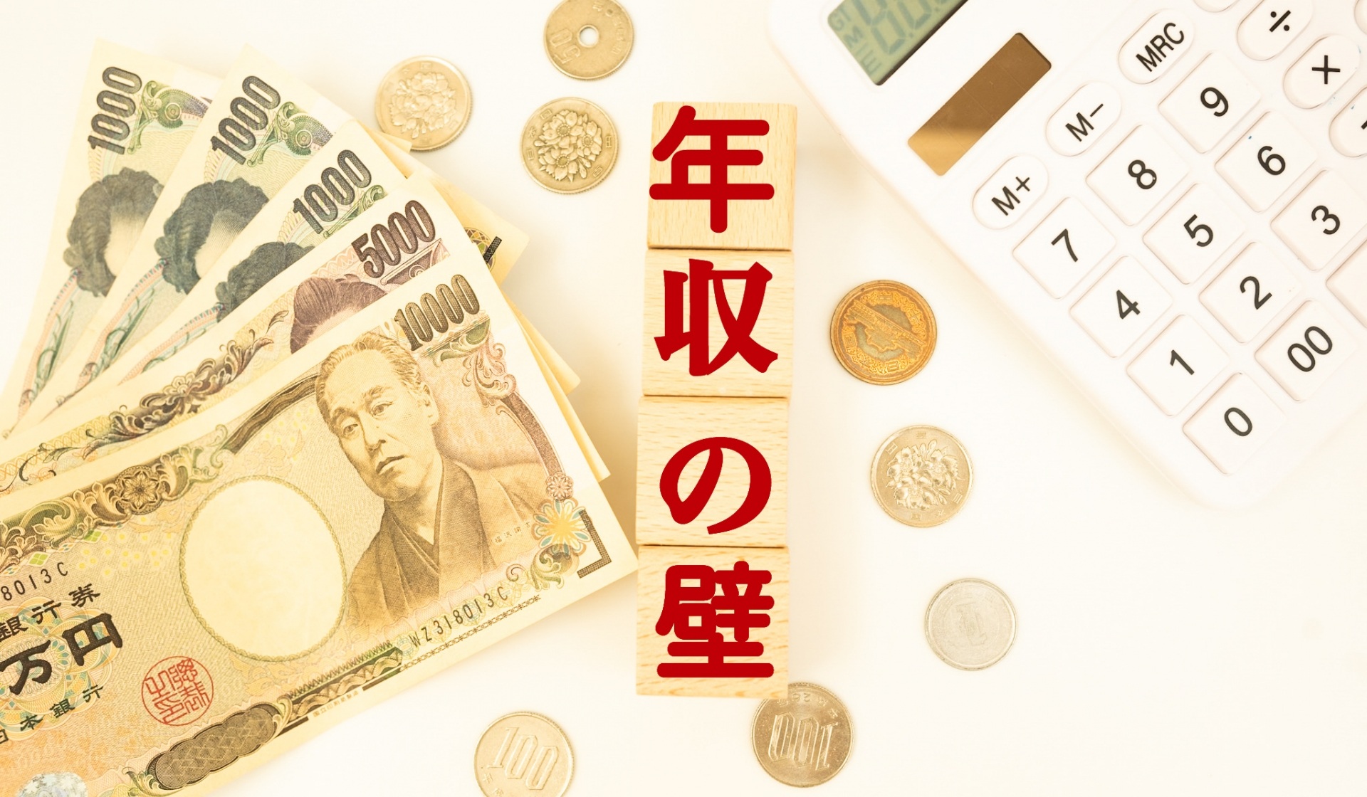 年収の壁と書かれたブロックとお金と電卓