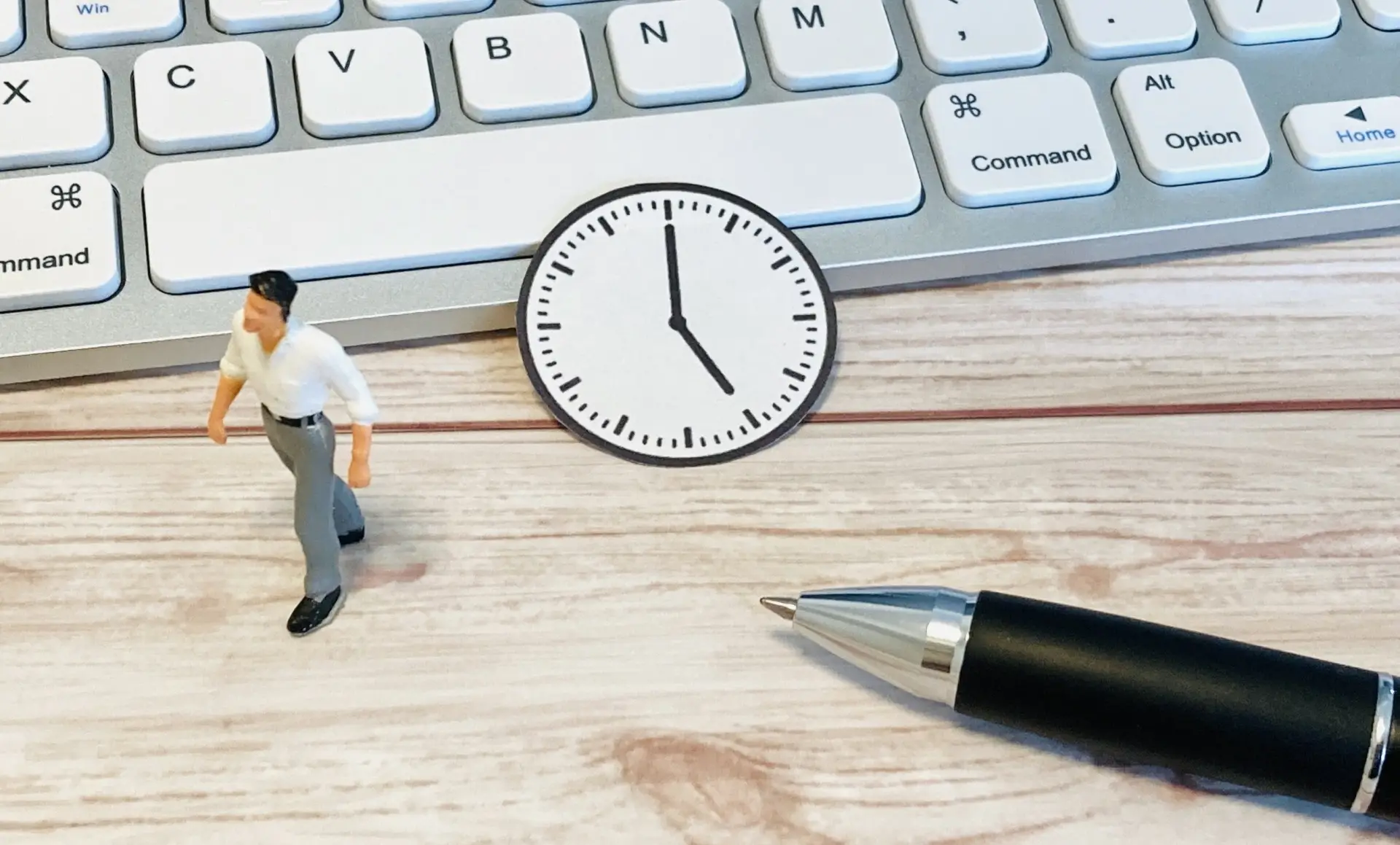 キーボードとミニチュアの人間、ペンと時計